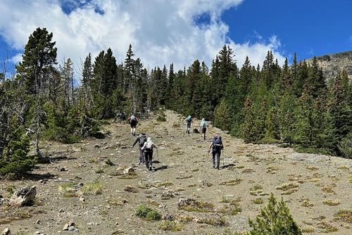Heading up to Monola Peak from it's east col