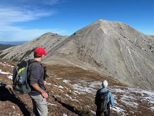Gary and Jack admiring 14 or 15 mountain goats and Moose Mountain fire lookout from near the West Peak of Moose Mountain.