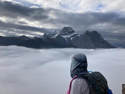 Sim enjoying the view of mountain summit "islands" appearing in the fog