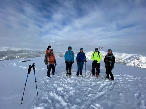 Small summit, smaller flag, big smiles