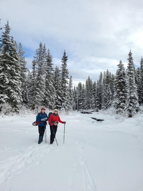 Teresa And Jane crossing the wide Smith-Dorrien Creek