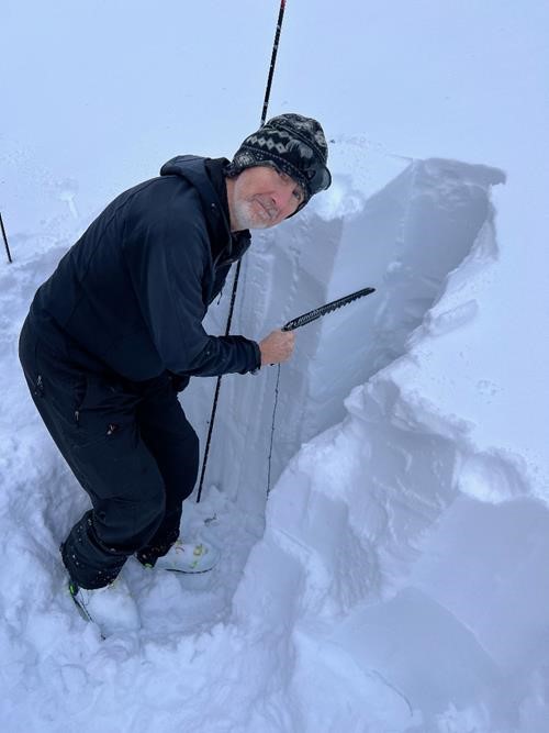 Peter intently studying the snow pack 