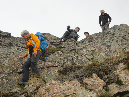 Ramblers downclimb small cliff on west end of Lusk Ridge East. This scramble was not neccessary but the alternate easier route led into deep snow. 