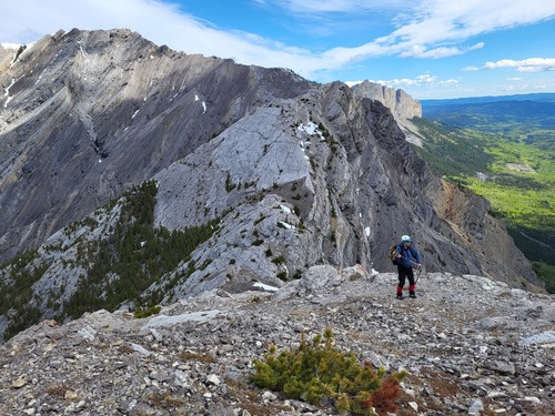Searching for a lunch spot out of the wind with Goat and Yamnuska in the background