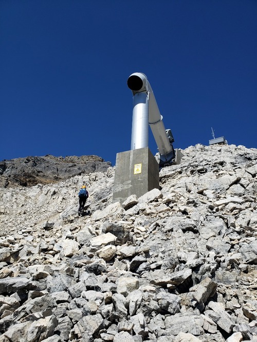 Tatyana climbing past the upper-most Gazex exploder just below the summit ridge. The summit of Mount Bosworth can be seen directly above her head.