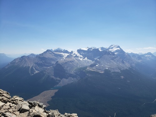 Ross Lake and the new clear-cut area, Mount Niblock, Mount Whyte, Narao Peak, Victoria North Peak, Mount Temple from the summit of Mount Bosworth.