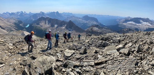 Ramblers reluctantly leaving the summit; Sherbrooke lake at left and Emerald at right