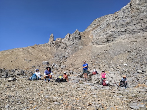 A well-deserved rest off the mountain; our descent gully is above John