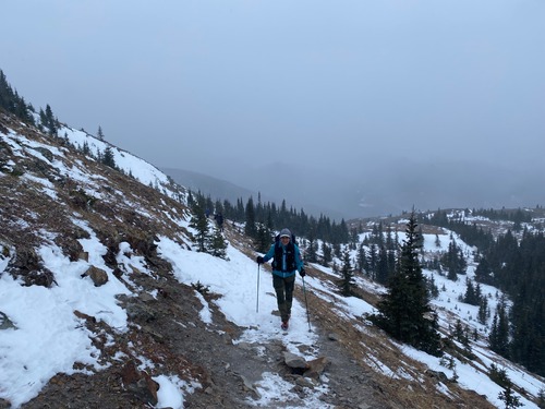 It's snowing and windy as we climb the big avalanche slope