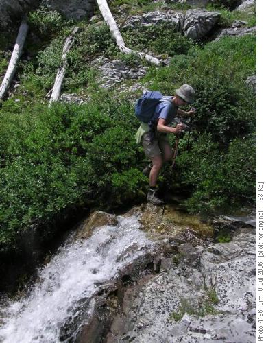 Ginger gingerly picks her way across the rocks at the south end of Weary Creek Gap tarn Ginger gingerly picks her way across the rocks at the south end of Weary Creek Gap tarn