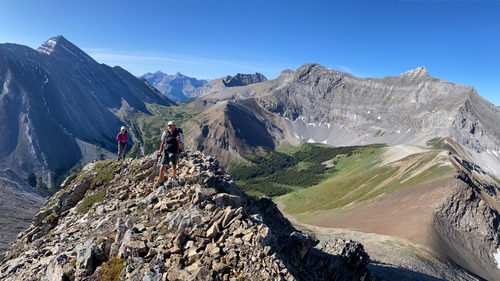 On the summit ridge of Brock's Peak; Aylmer Pass above the figures and our camp just right of centre