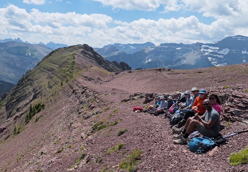 Most of the group enjoying a relatively sheltered spot with lake views for lunch, while a few others followed Rambler tradition and headed for the top in the background.
