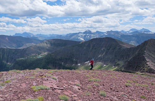 A sea of peaks behind Arnold at the summit of Lineham Ridge.