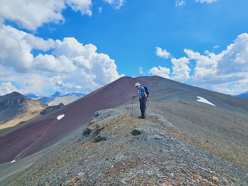 Doug examining some of the scree types on the col below Purple Mound