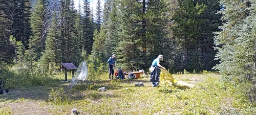Bob and Jane sort gear at Howse Pass in BC while hiking the GDT section D.