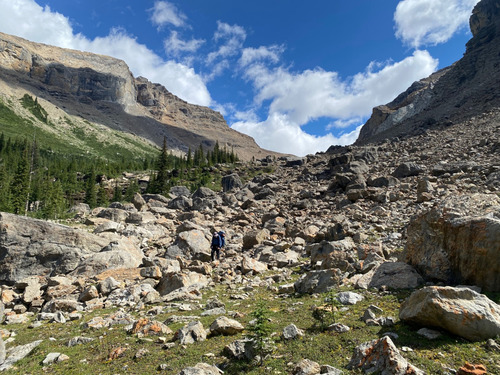 Bob descends a boulder field north of Kiwetinok Pass, BC while hiking on the GDT
