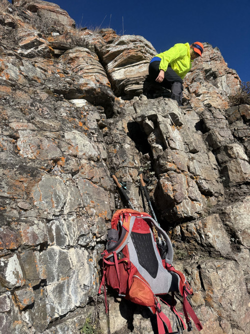 Rambler climbs the crux sramble rock on Wind Ridge