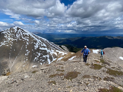 Lots of snow on Boundary Peak at the left, and heavy rain in the distance 