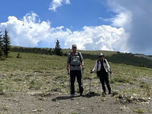 Dave and Jeannette with the stark sandstone of Powderface Ridge behind them 