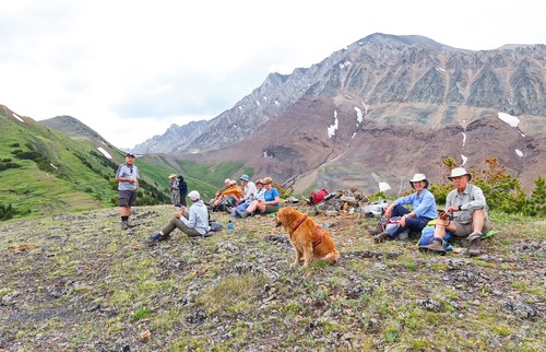 Lunchtime on a minor hump, under looming clouds with the summit in the left background. 