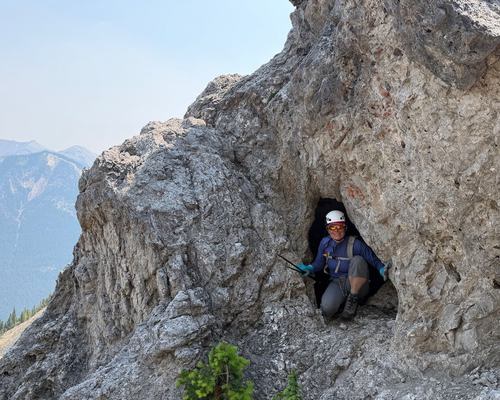 Tana in the cave below Anklebiter summit (more than 10 feet deep)