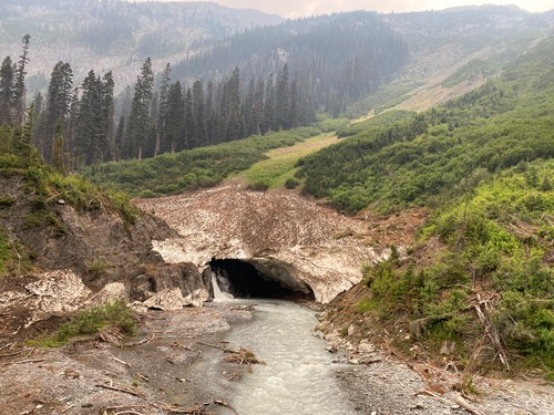 Avalanche debris with tunnel and waterfall 