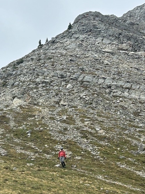 Jeanine arriving back on grass at the base of the descent ridge