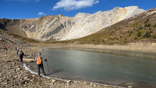 Testing the ice thickness at the Harvey Pass tarn (photo by Linda)