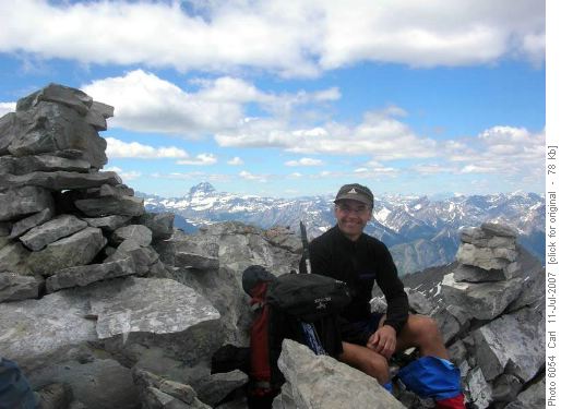 Stuart at the summit of The Tower (Assiniboine in the background)