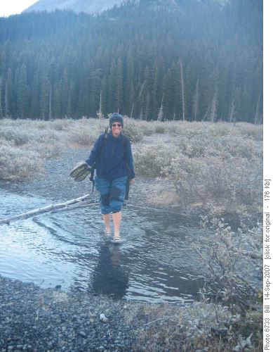 Eva crossing the Robertson Glacier creek